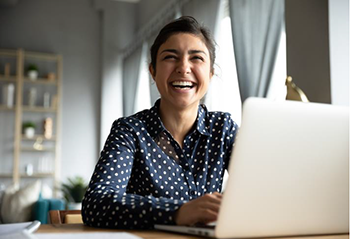 Woman with laptop, smiling, happy