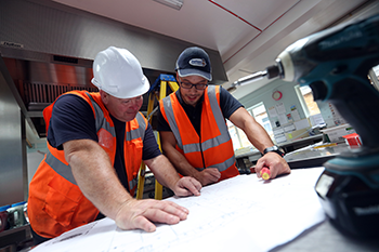 Two builders looking at construction plans