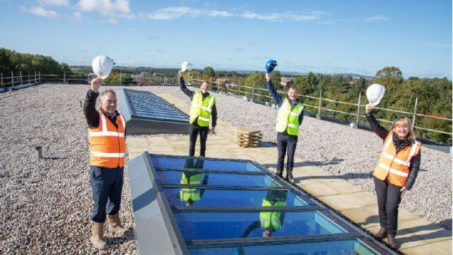 Bowburn Primary School - Team stood on the completed roof of building.