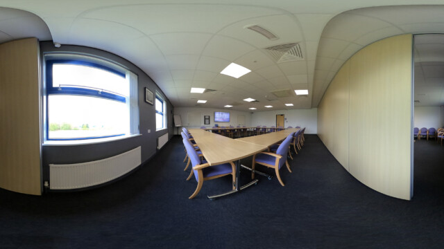 An image of a meeting room in boardroom setup