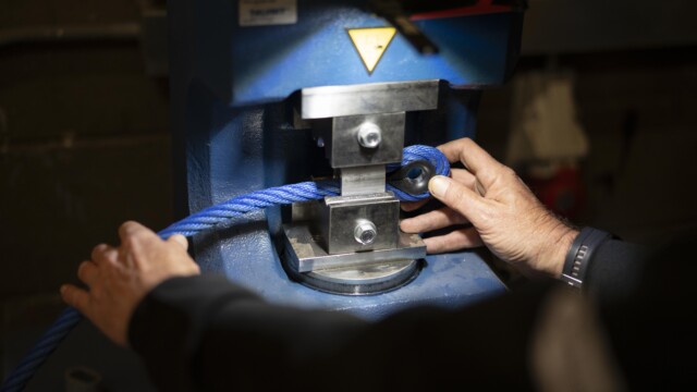 Blue playground rope being put through the machine