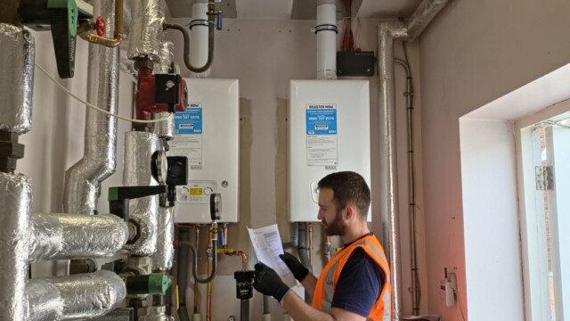 Engineer assessing paperwork of boiler
